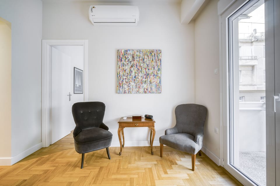 Living area featuring smart TV, high speed WiFi, AC and full length balcony