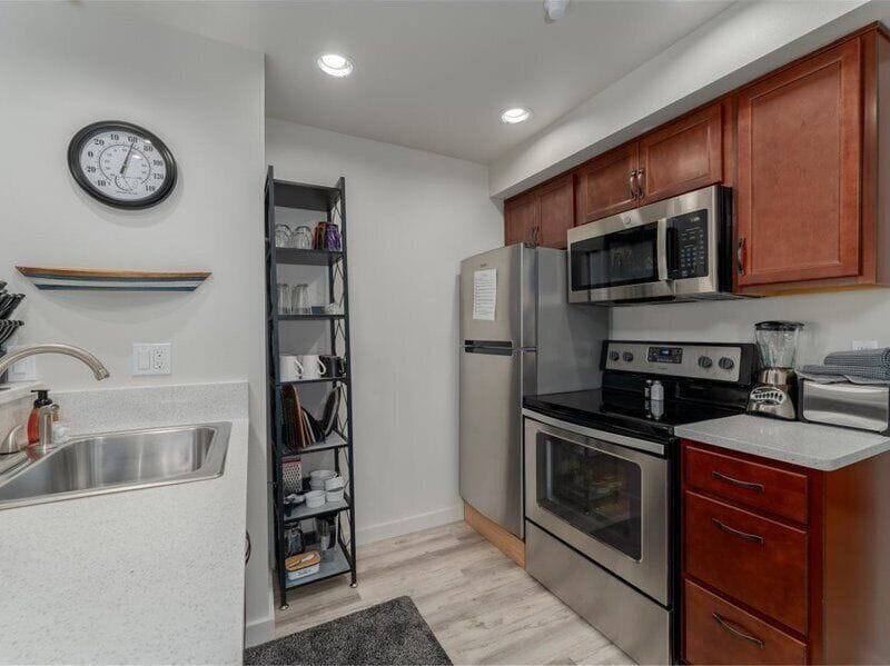 Your fully equipped kitchen offers stainless steel appliances and warm cherry cabinets, perfect for preparing meals during your stay.