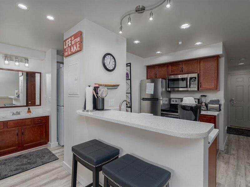 Your open kitchen features modern appliances and a breakfast bar where you can enjoy morning coffee while planning your day.