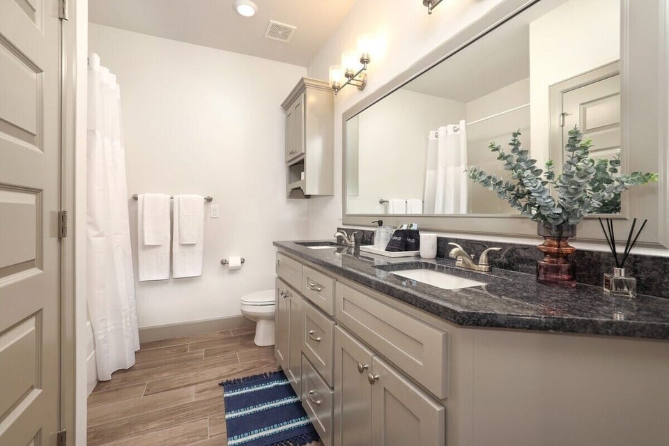 Our second full bath, complete with a shower + tub combo and a spacious vanity.