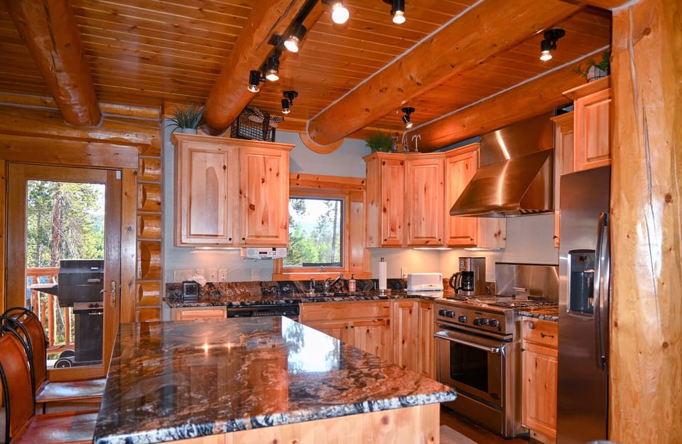 Kitchen. Step out the door to another deck with a grill.