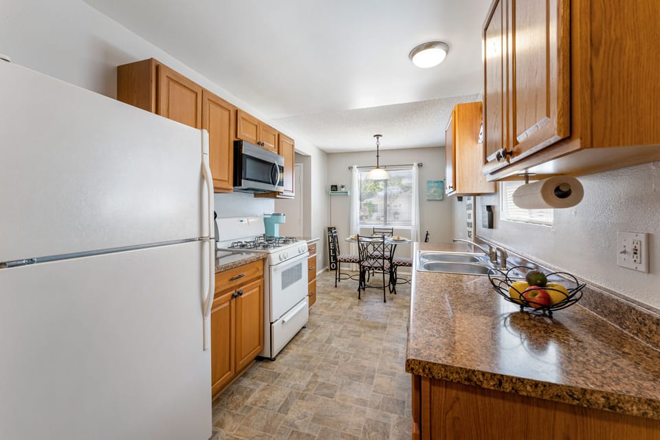 Fully stocked remodeled kitchen with pantry and extra cabinet storage.