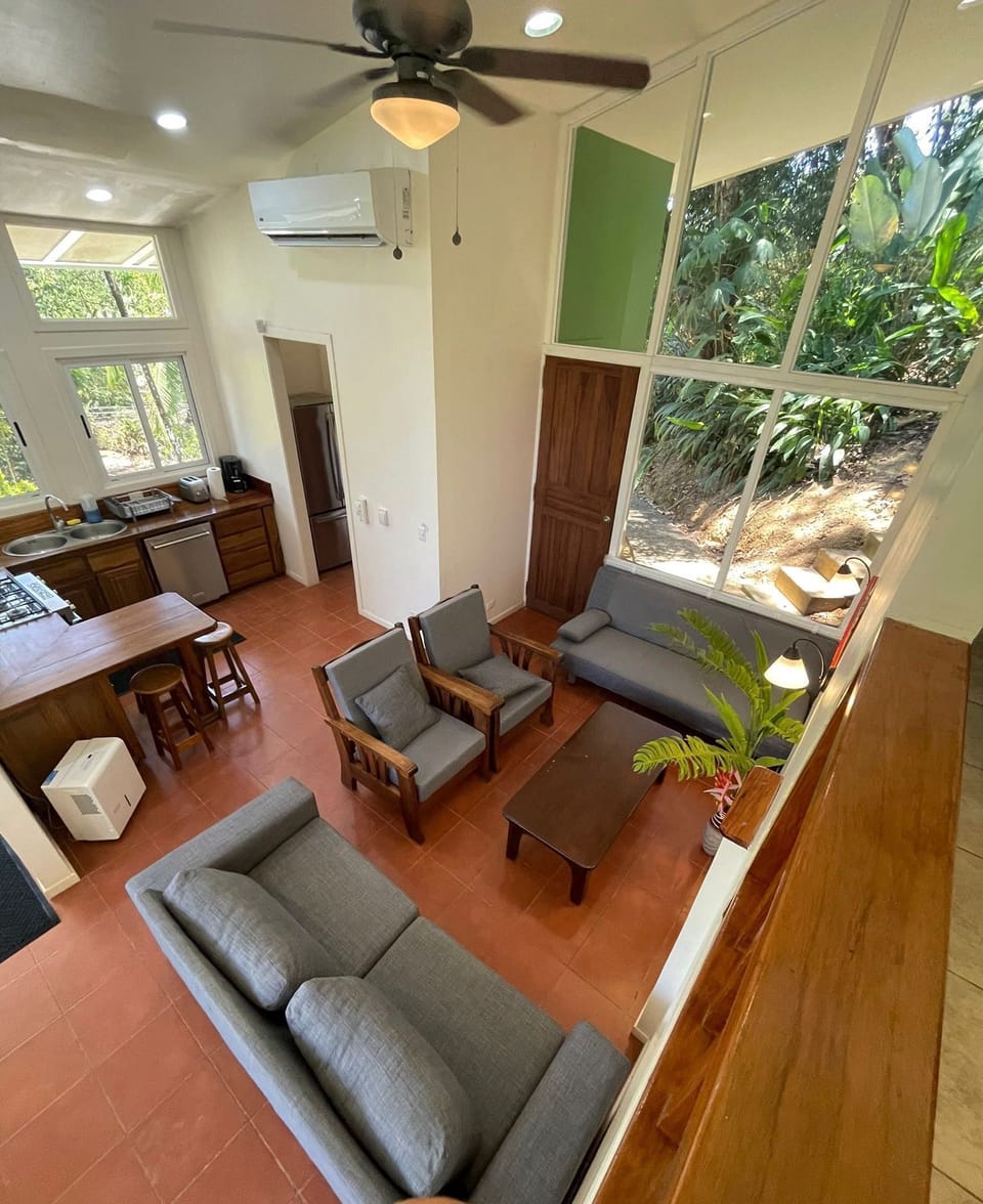 Air conditioners and ceiling fans in both  the living room and bedrooms. 