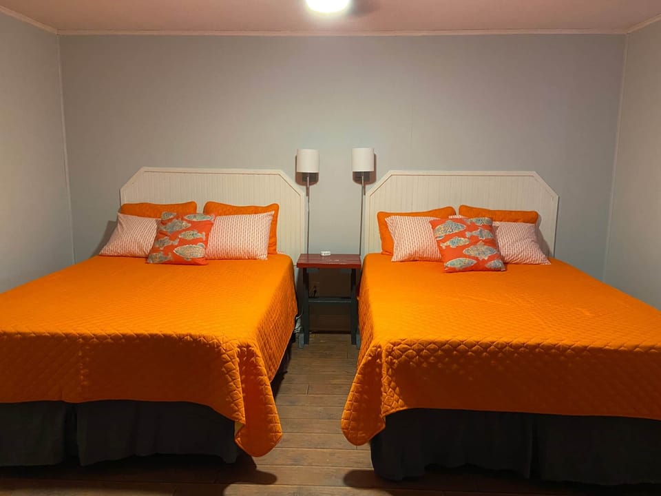 Two queen size beds. Ceiling fan and AC unit.