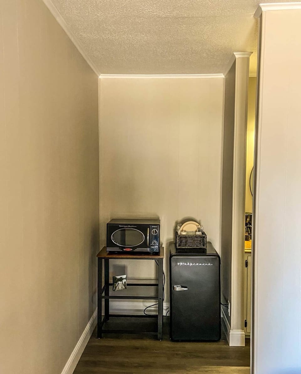 Retro microwave and refrigerator with plates, coffee and utensils 