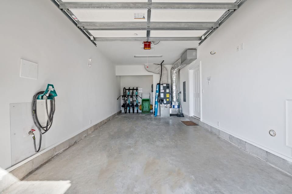 Garage parking with Bikes, fridge and beach toys, cart and rolling cooler.