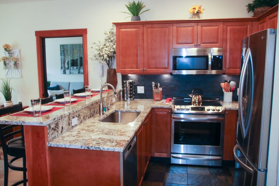 Well stocked and spacious kitchen with granite counters and NEW appliances
