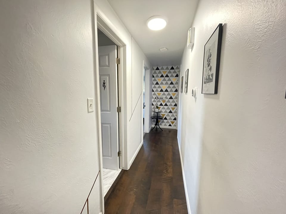Hallway that leads to bathroom and 2 bedrooms
