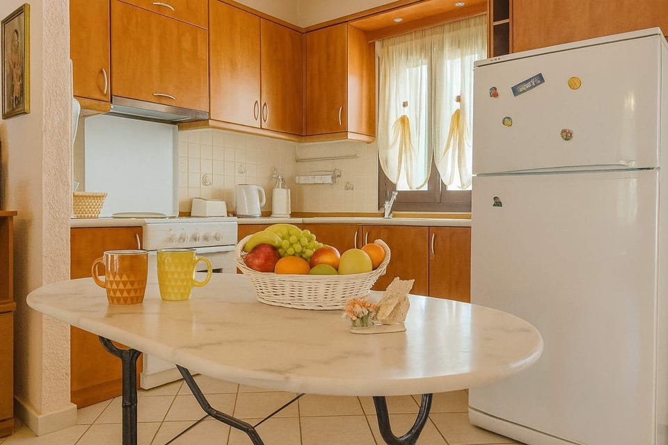 Discover the light-filled and contemporary kitchen, designed to cater to your culinary needs with modern appliances, sleek surfaces, and a cozy dining corner overlooking the garden.