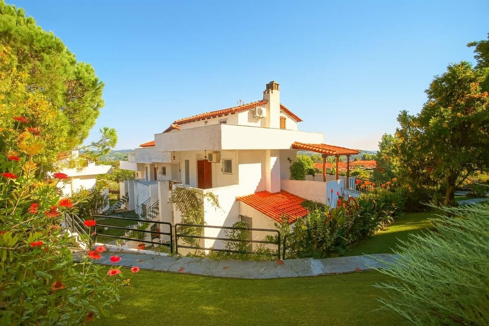 Take in the villa’s beautiful exterior, surrounded by manicured lawns, blossoming gardens, and ancient olive trees, creating a peaceful and picturesque setting for your holiday.

