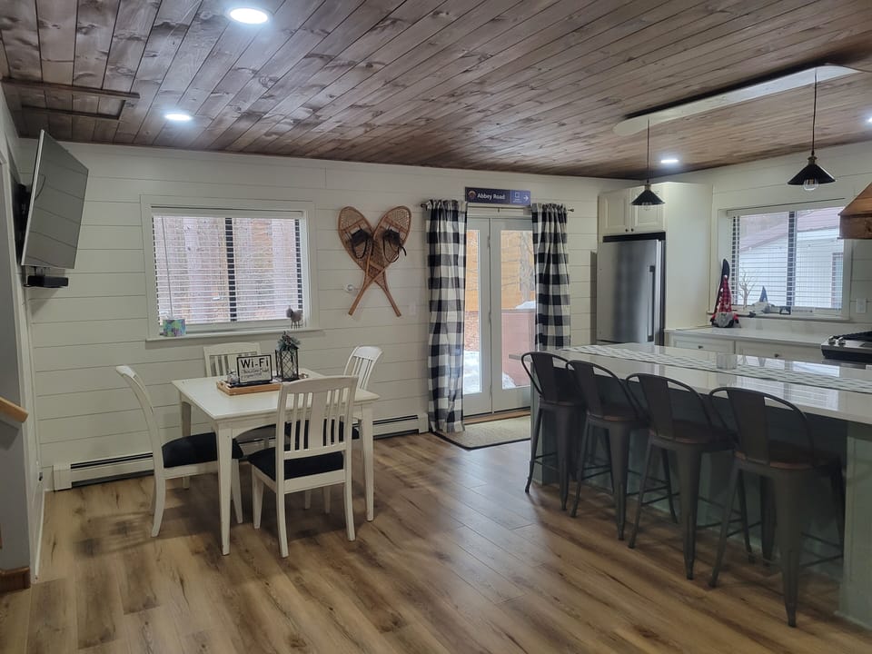 Dining area with seating for 8 at table and island.