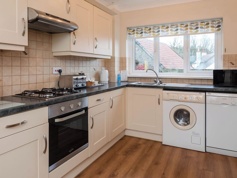 Kitchen | Dolphin Cottage - Celtic Haven Resort, Lydstep, near Tenby