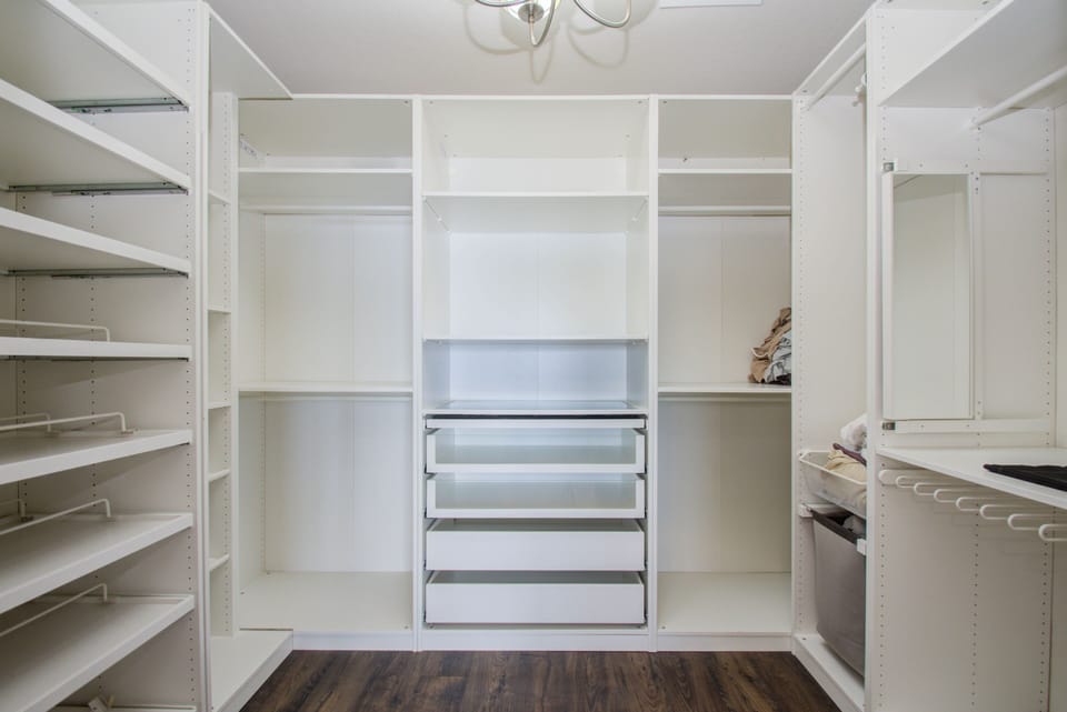 Large walk in closet with lots of storage 