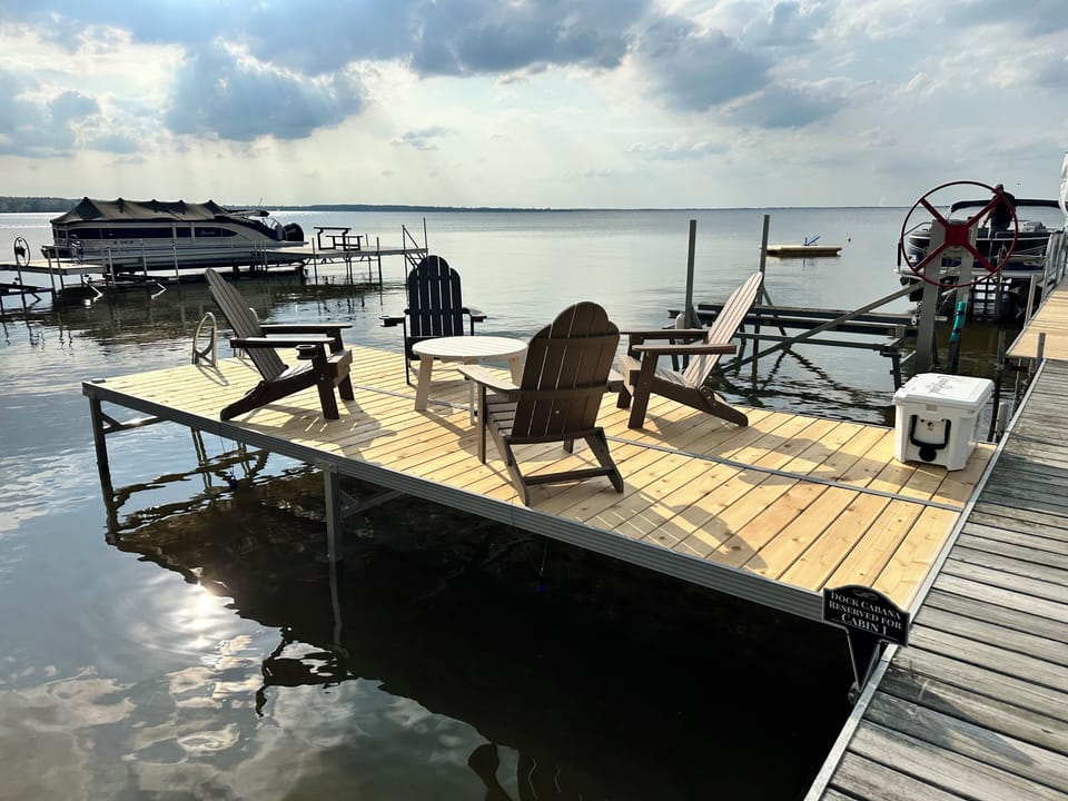 Imagine soaking up the summer sunshine here! Private lakefront deck for Cabin 1.