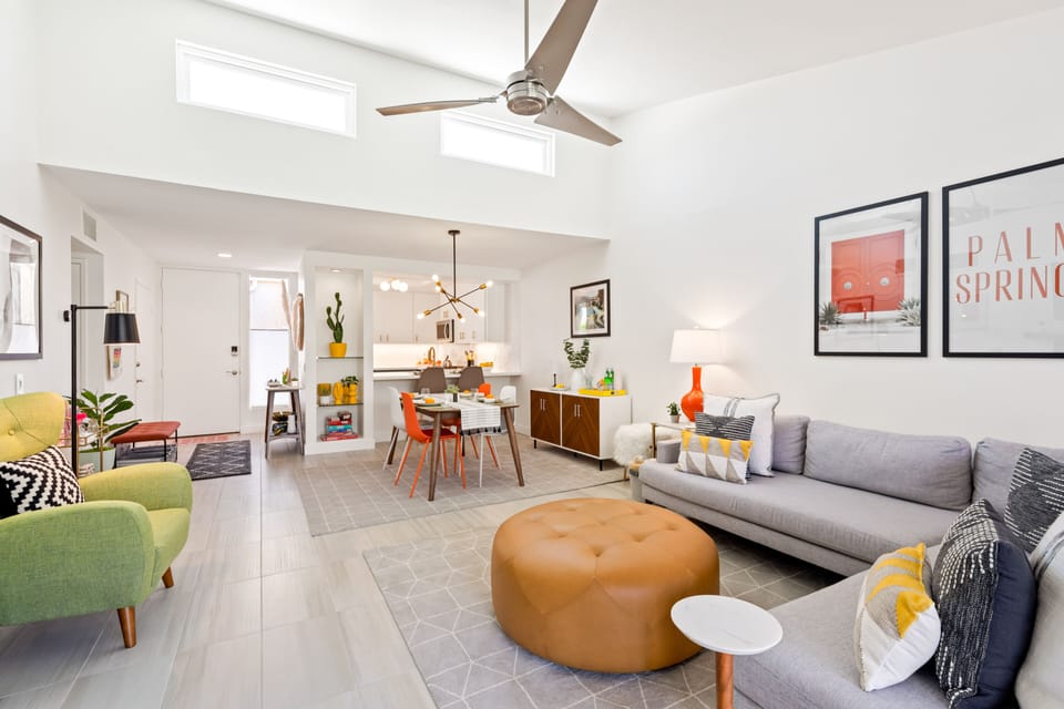The colorful and stylish living room features a large comfy sectional.