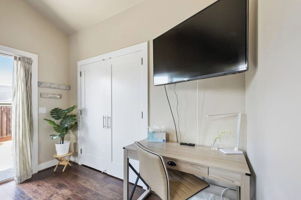A dedicated work station and a smart TV in the master bedroom (1).