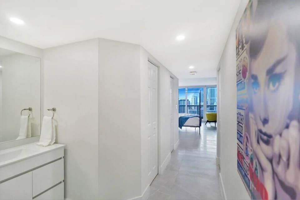 View from master bathroom of vanity area, large walk in closet with safe