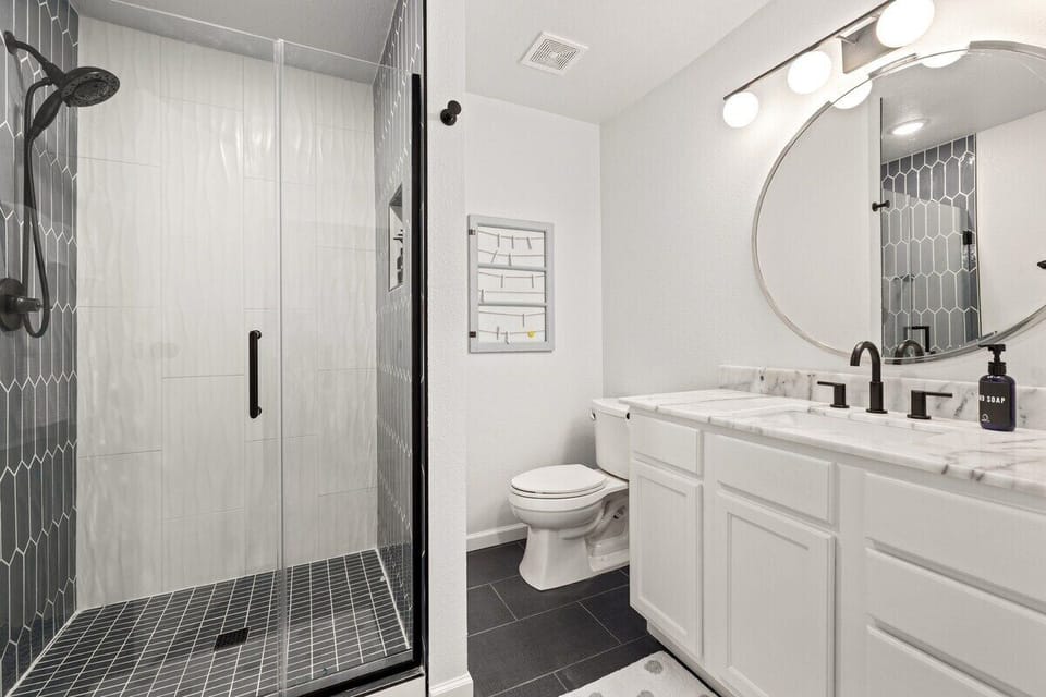 NEWLY RENOVATED!! This bathroom features a spacious walk-in shower + fully stocked.