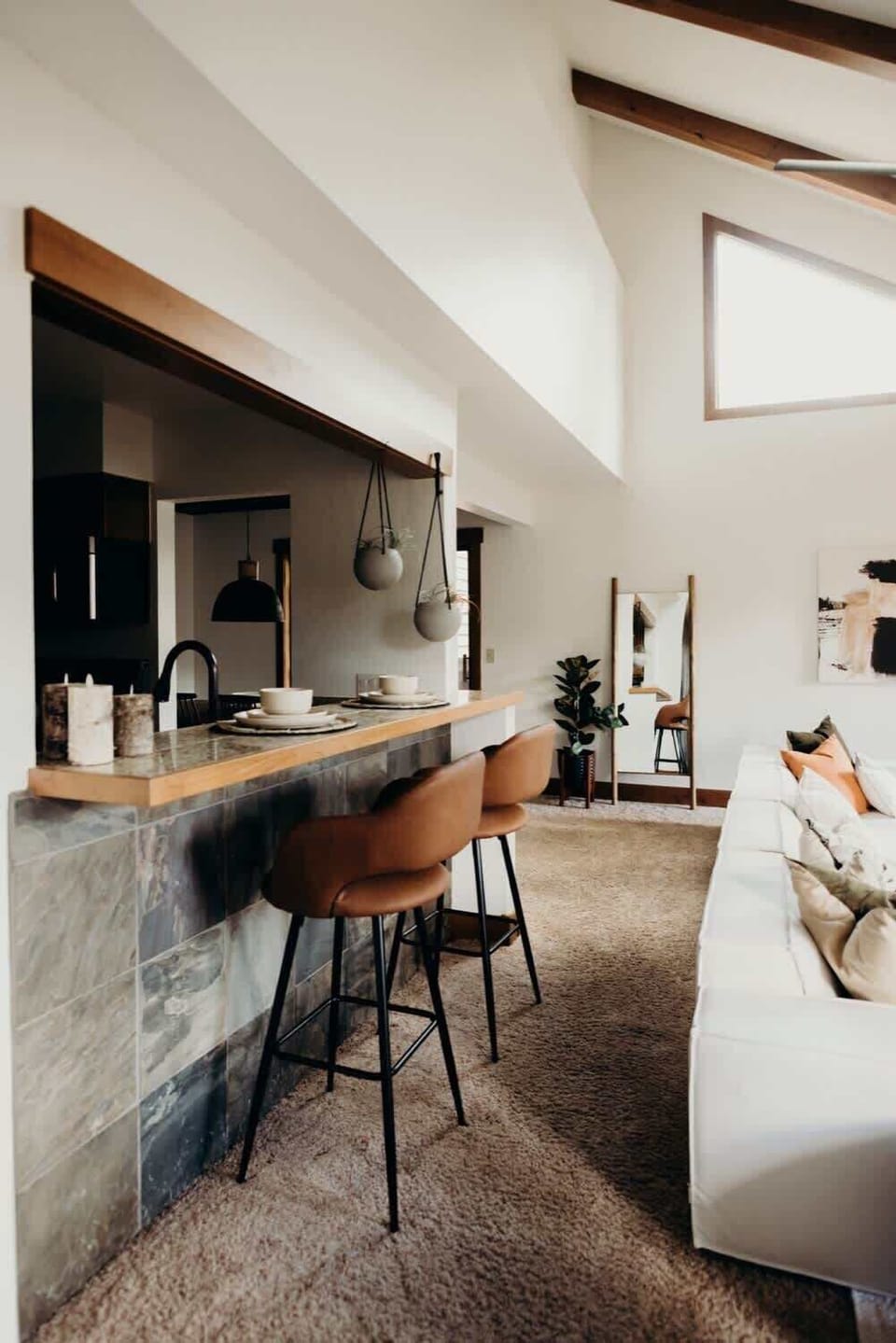 Living room with bar-style seating at the kitchen counter