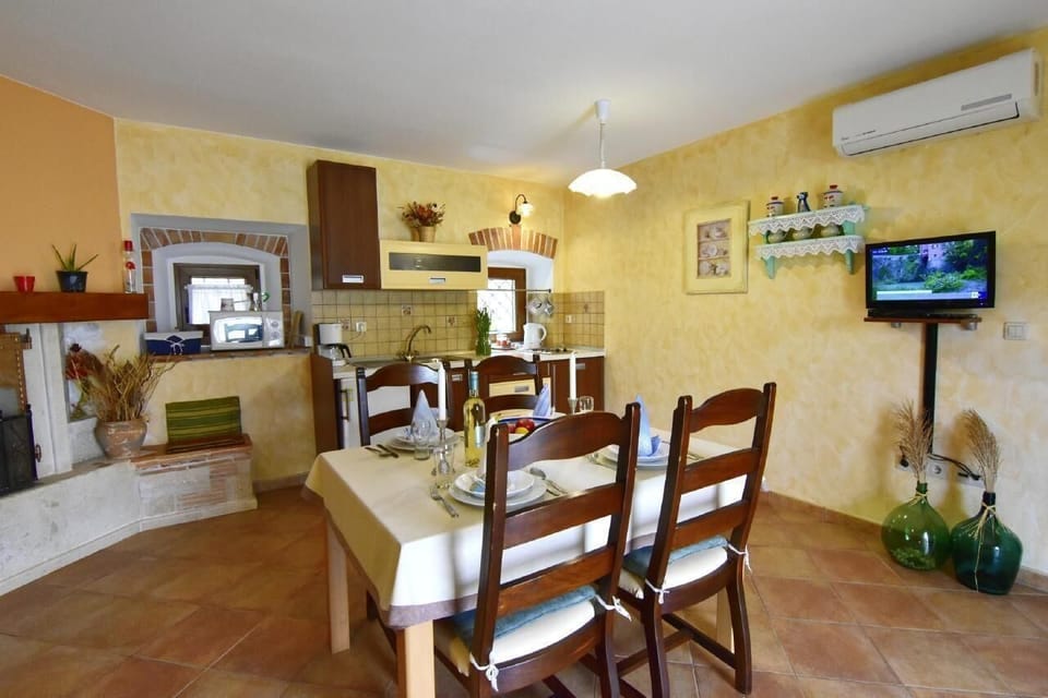 The living area with dining table and kitchen.