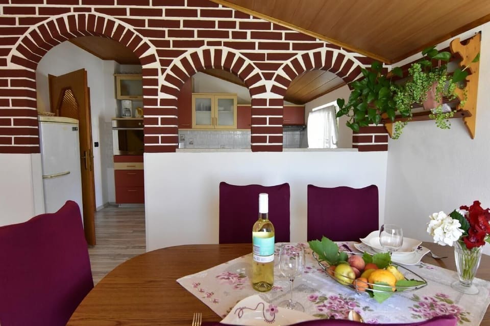 The dining room with table and chairs separated from the kitchen.