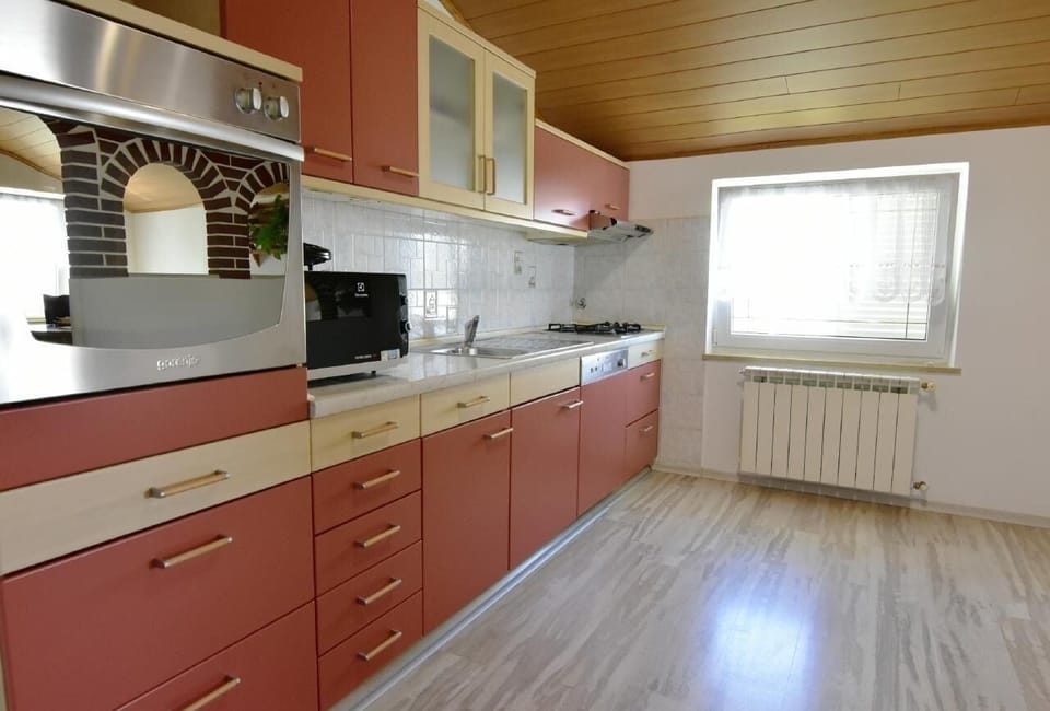 The kitchen equipped with an oven, stove, coffee maker, dishwasher, microwave