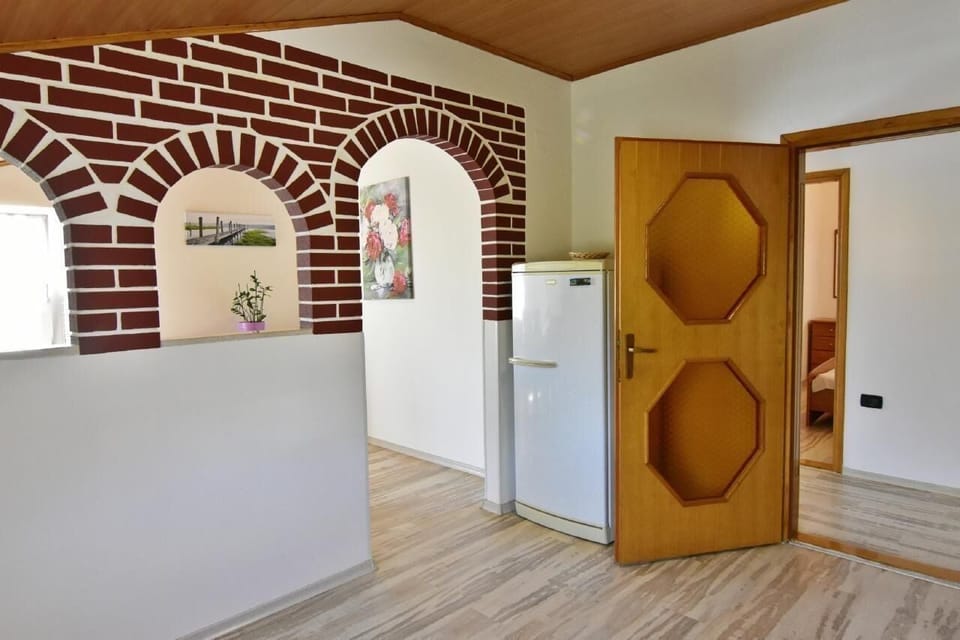 The entrance from the kitchen to the dining room and refrigerator with freezer area.