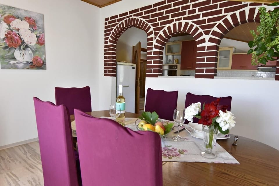 The dining room with table and chairs separated from the kitchen.