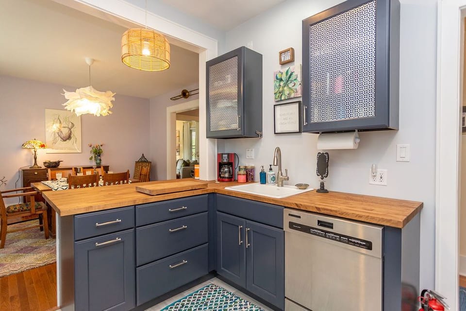 The colorful kitchen has coffee and tea, and a dishwasher.  