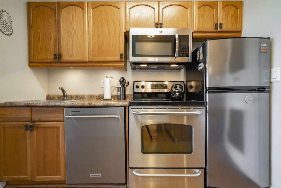 Kitchen is stocked with essentials including spices, oils, coffee, pots and pans