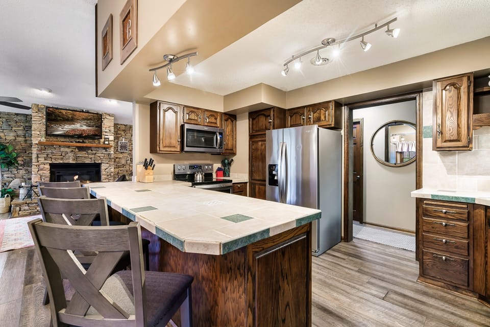 Fully equipped kitchen with bar seating and dinning table.