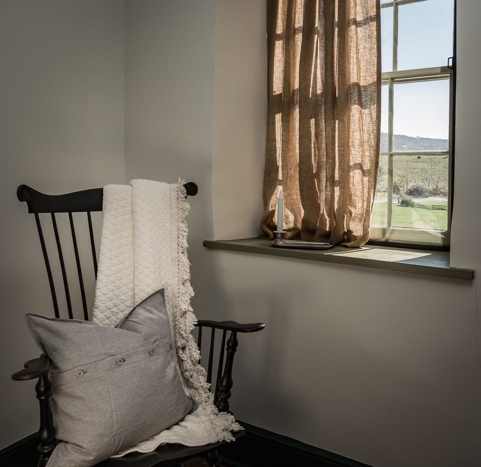 Handmade Windsor rocking chair in a quiet corner of the Washington bedstead room