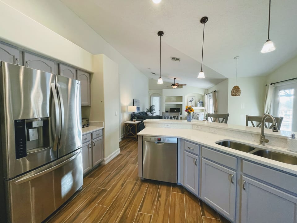 Roomy, open kitchen ensures cook can interact with guests and enjoy a pool view.