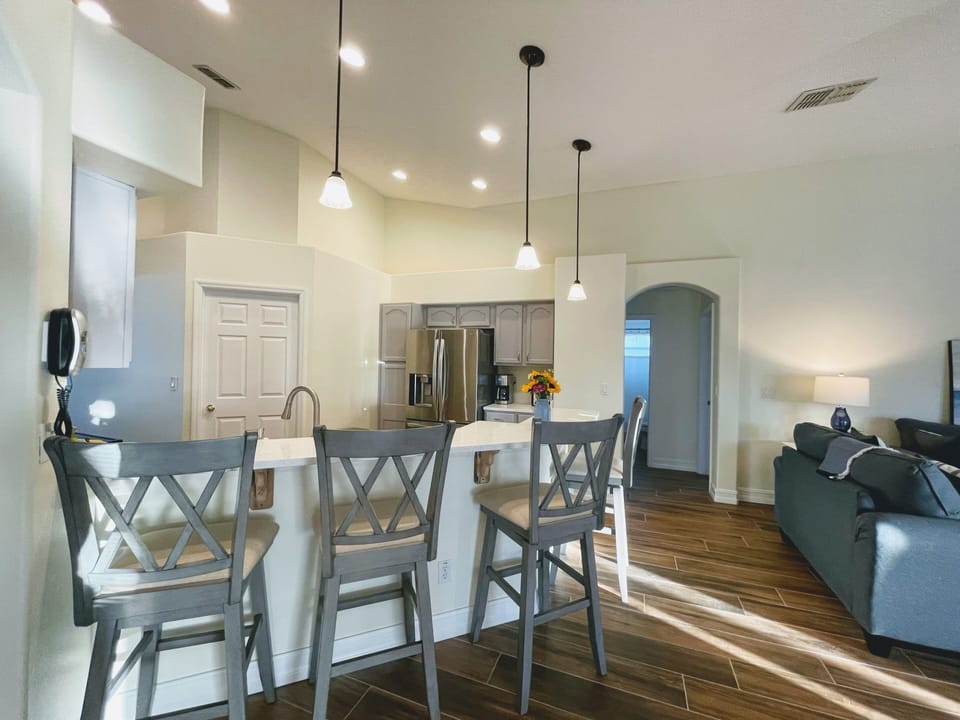 Open concept kitchen with breakfast bar seating four.