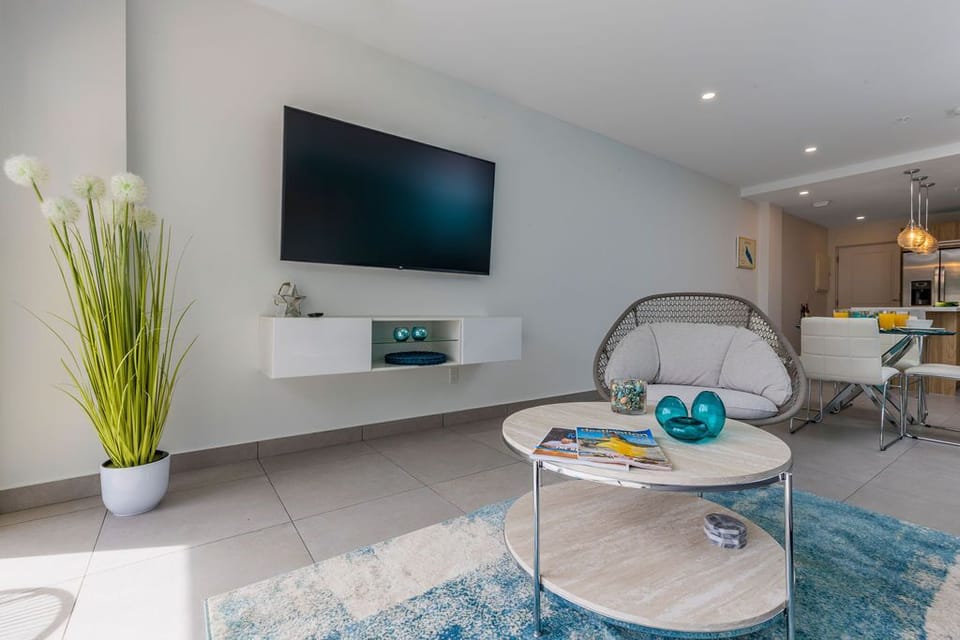 Your private bathroom features a sleek walk-in shower, modern fixtures, and thoughtful touches like fluffy towels and organized toiletries—ready for you to unwind.