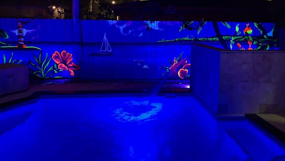 View of pool at night that lights up