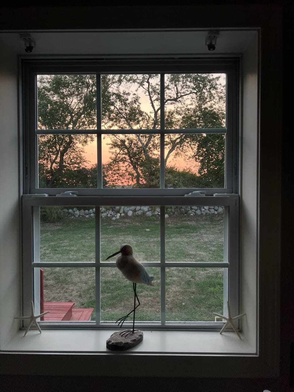View from kitchen to golf club and sunset