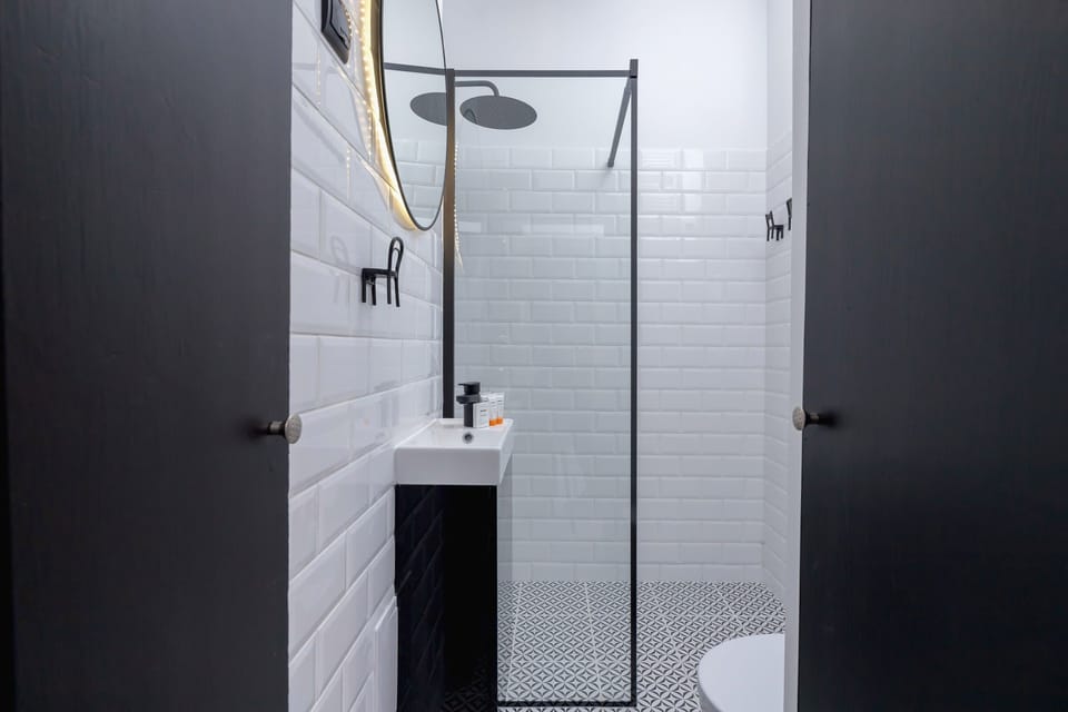 Bathroom with a shower, sink, mirror and toilet.
