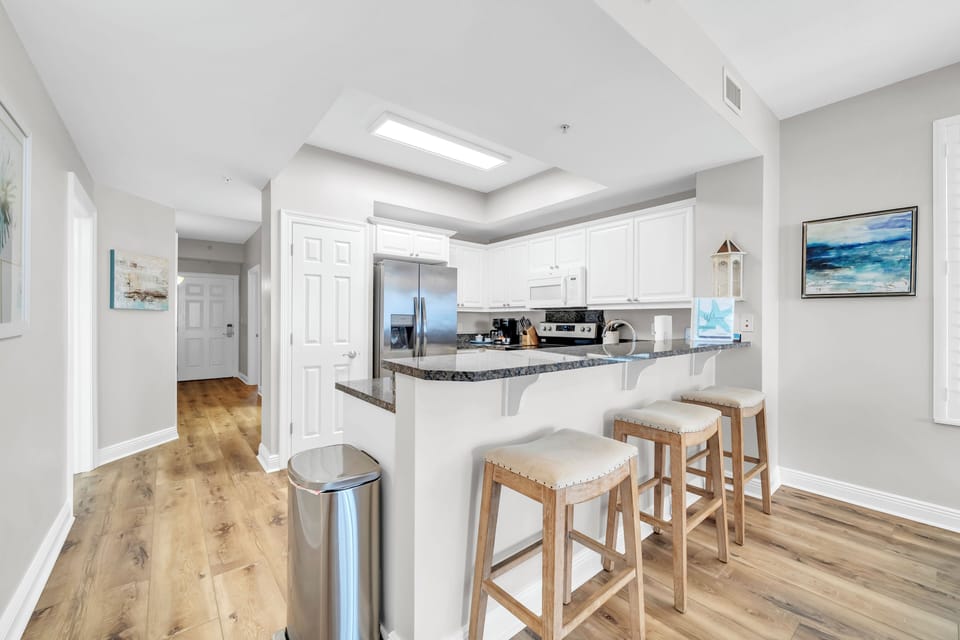 Your fully-equipped kitchen features granite countertops, stainless steel appliances, and a breakfast bar where you can enjoy morning coffee together.