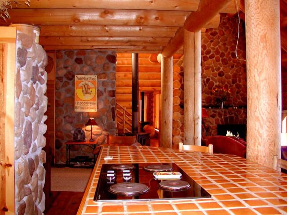 Cook island view to open den with piano (piano not showing)