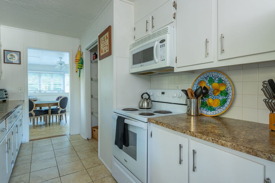 Kitchen with dishwasher, tea kettle, standard Drip-style coffeemaker & toaster oven.
