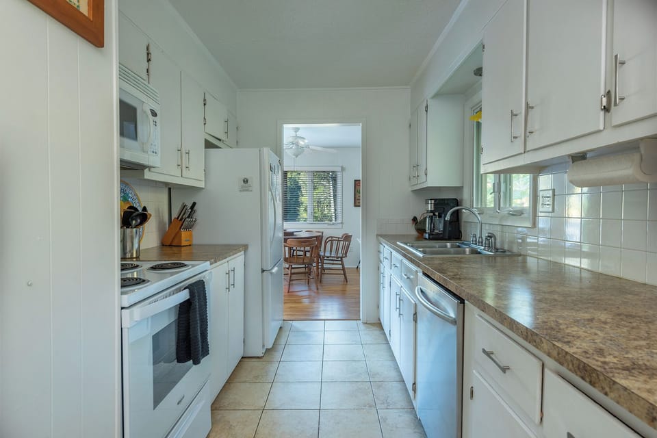 Kitchen with dishwasher, tea kettle, standard Drip-style coffeemaker & toaster oven.