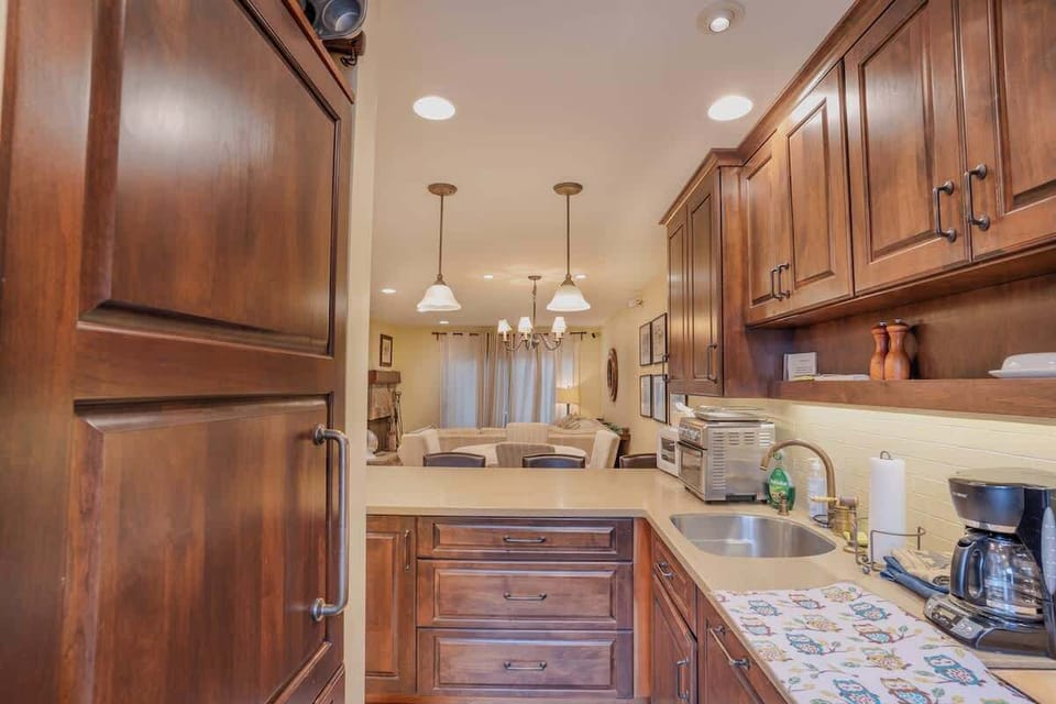 Fully Stocked Kitchen with Custom Fridge Shown on the Left