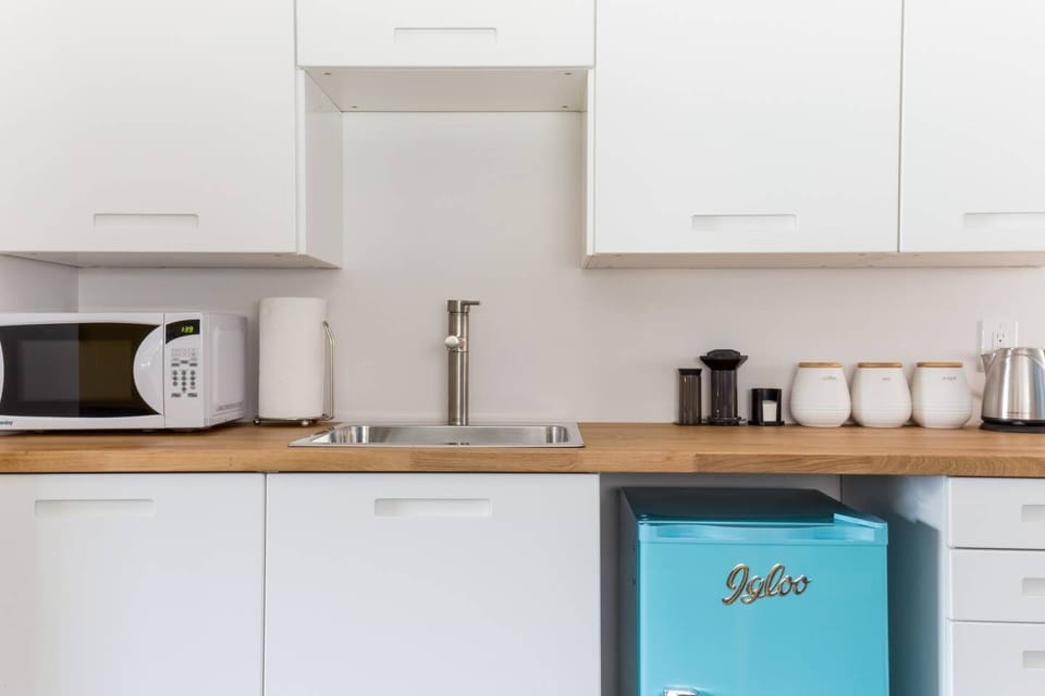 Your kitchenette includes a microwave, sink, fridge, dishes, cutlery, mugs and glassware