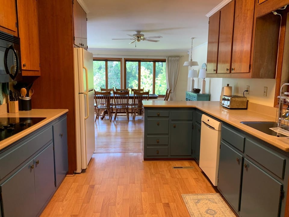 Kitchen looking to dining room. Microwave, stove, oven, dishwasher, toaster, etc