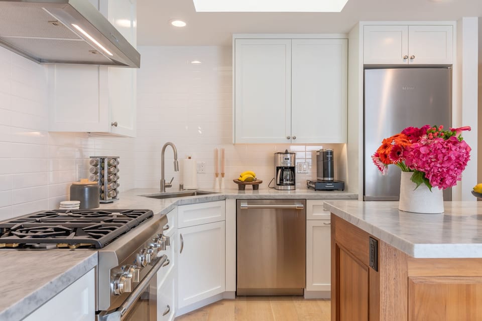 Thermador Gas Range and Carrara Marble Top kitchen 