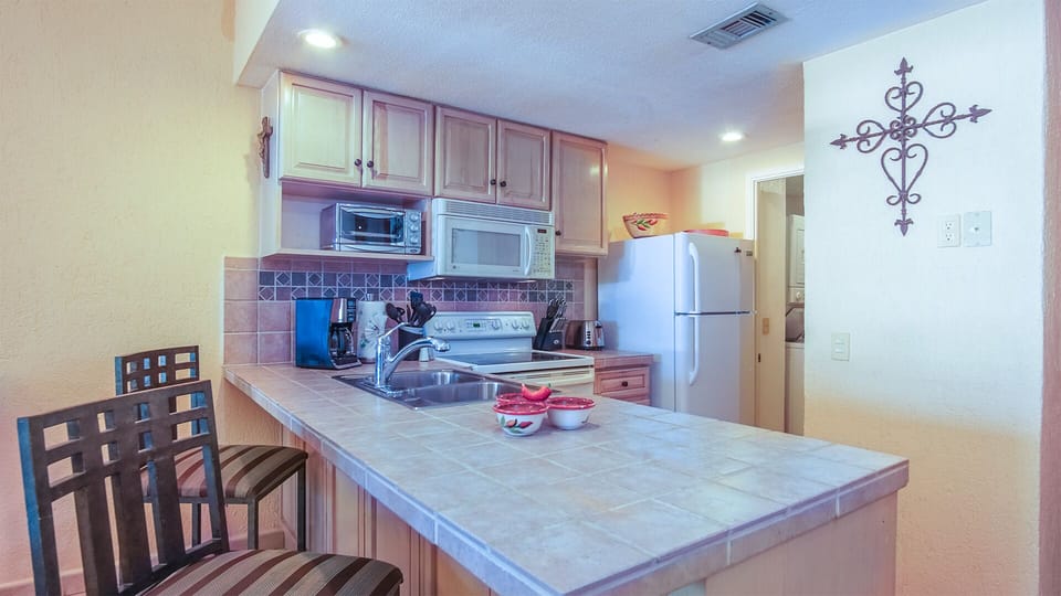 The kitchen is complete, with a large counter top, and additional seating.