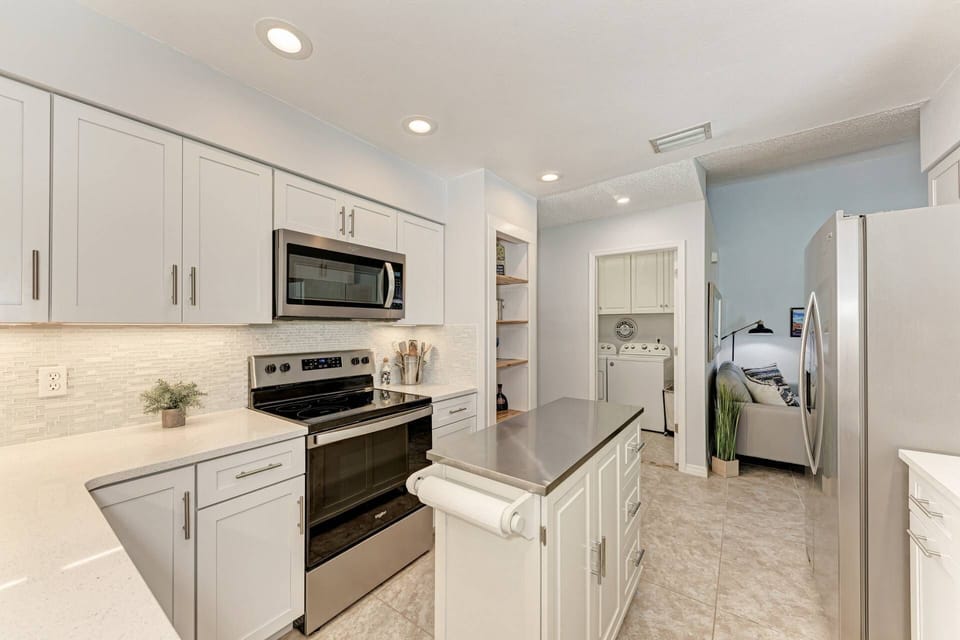 Full size washer and dryer in the laundry room just off the kitchen