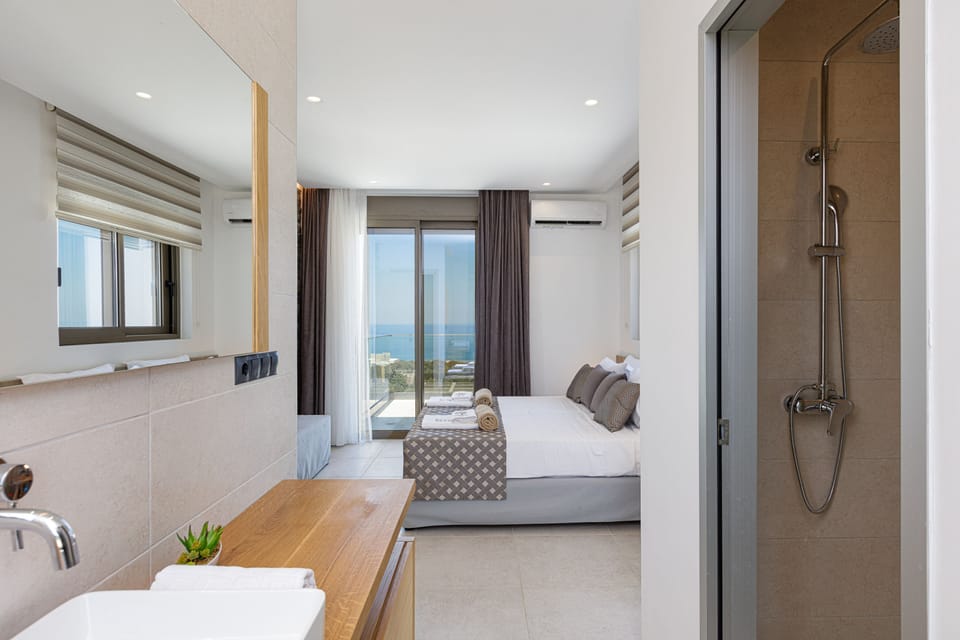 It includes an ensuite bathroom with a walk-in shower, a walk-in closet, and a private balcony