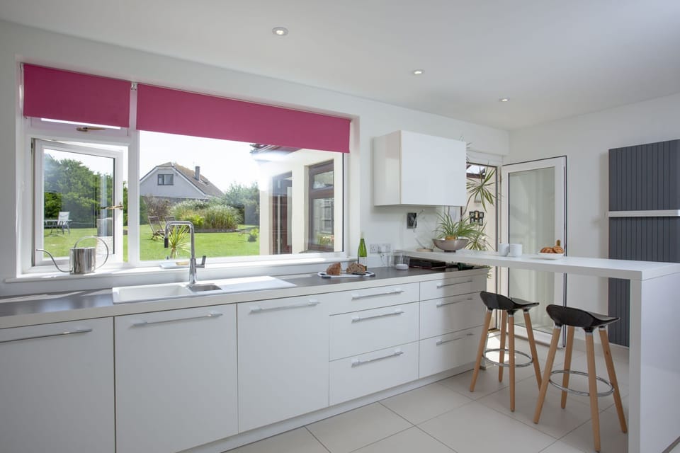 A breakfast bar and dishwasher with views to the garden - Little Close